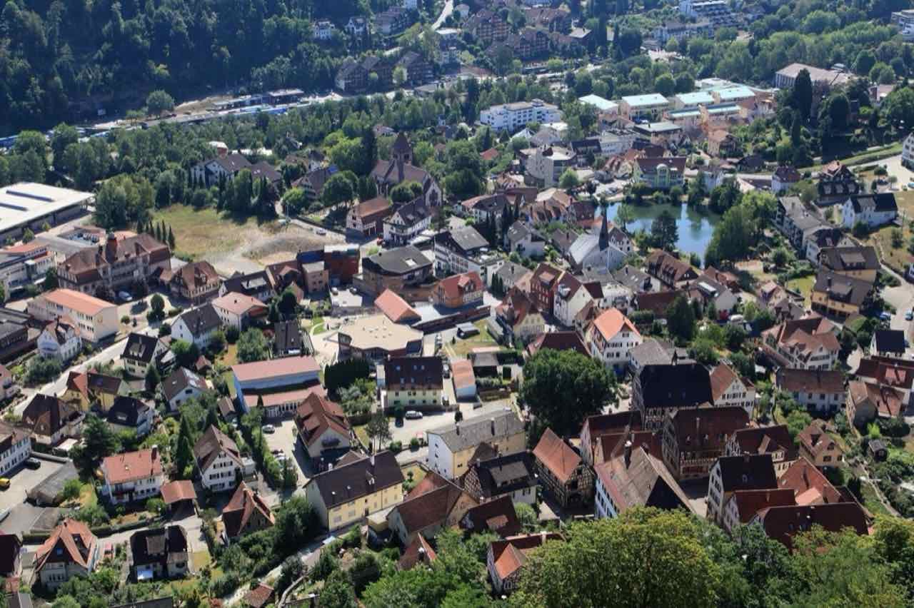 Aerial view of the centre of Bad Liebenzell from Burg Liebenzell, with half-timbered houses, a small lake and forested hills