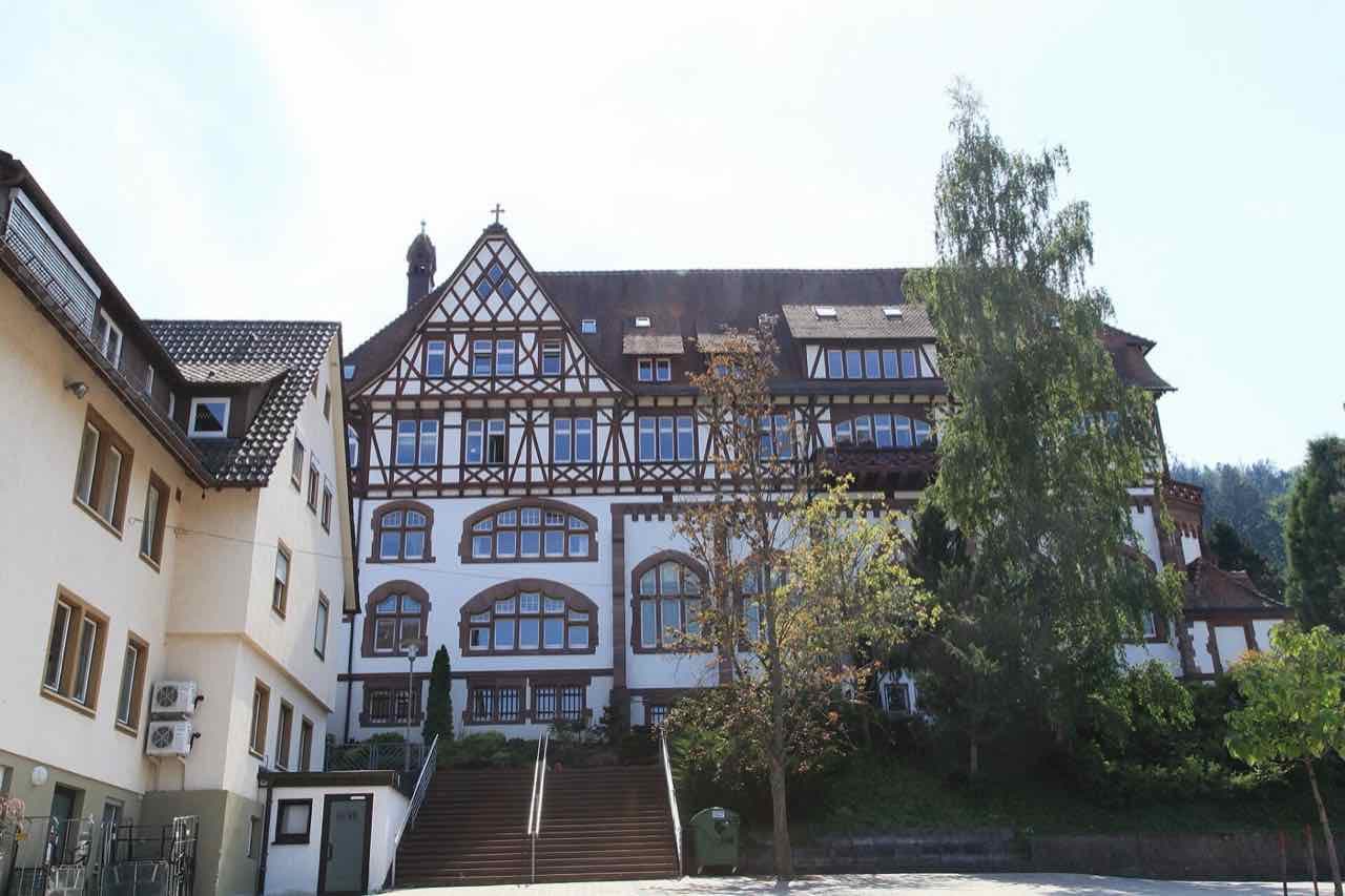 Half-timbered Liebenzell Mission building at the end of a stair on the hillside