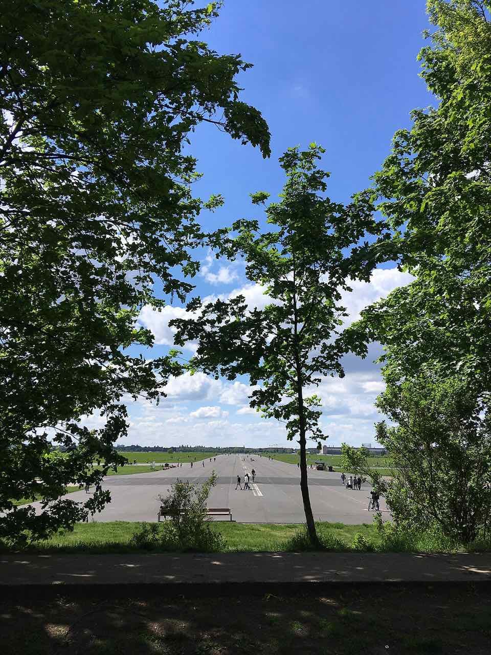 A long straight runway of the former Tempelhof airport, now an open park, under a wide sky