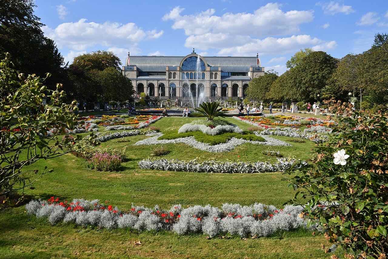 The Flora botanical garden in Cologne with flower beds and a glass house