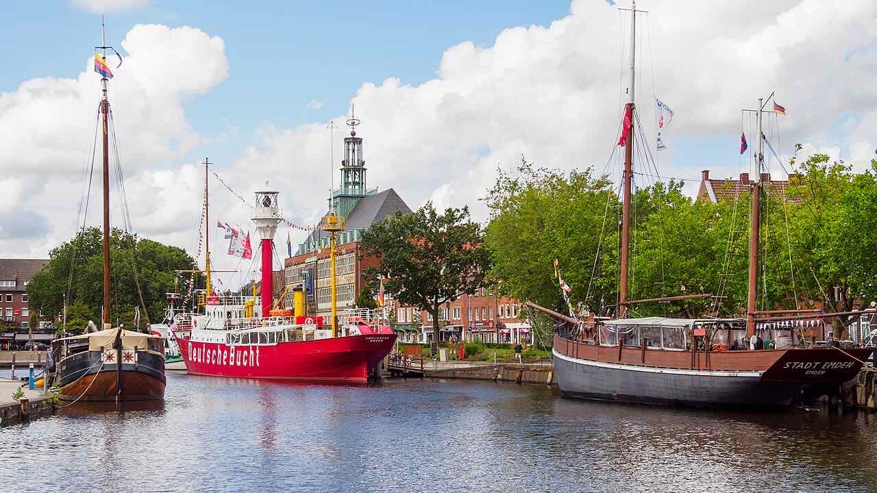Historic ships moored on the Ratsdelft in Emden, among them a red lightship marked Deutsche Bucht and a sailing barge named Stadt Emden