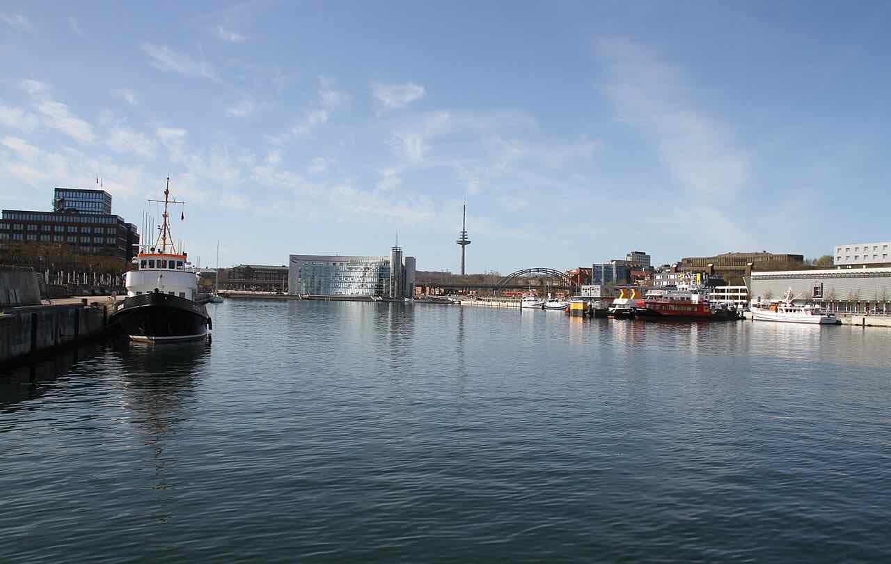 The Hörn, the southern end of Kiel harbour, with a moored ship, the glass SEALEVEL building and the television tower on a bright day