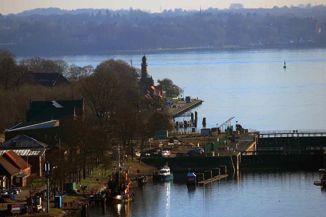 Holtenau on the Kiel Fjord, with a small lighthouse and lock gates among bare trees and the open water behind