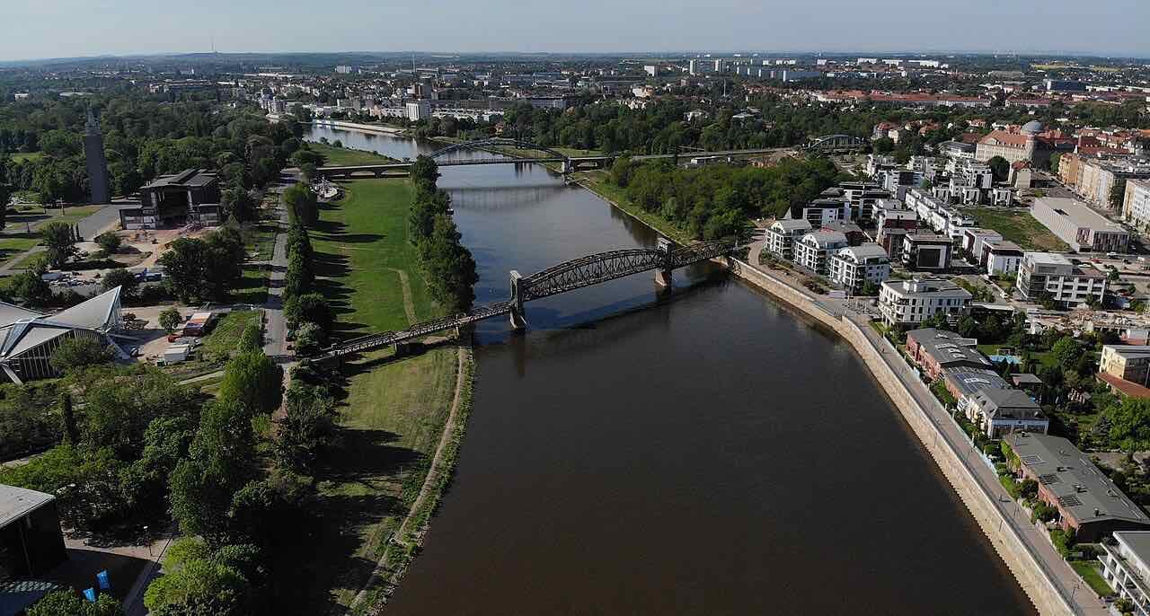 Aerial view of the Elbe in Magdeburg with the steel Hubbrücke bridge and green riverbanks