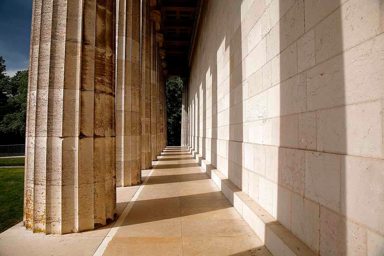 The long stone colonnade of the Walhalla temple above the Danube in low sun