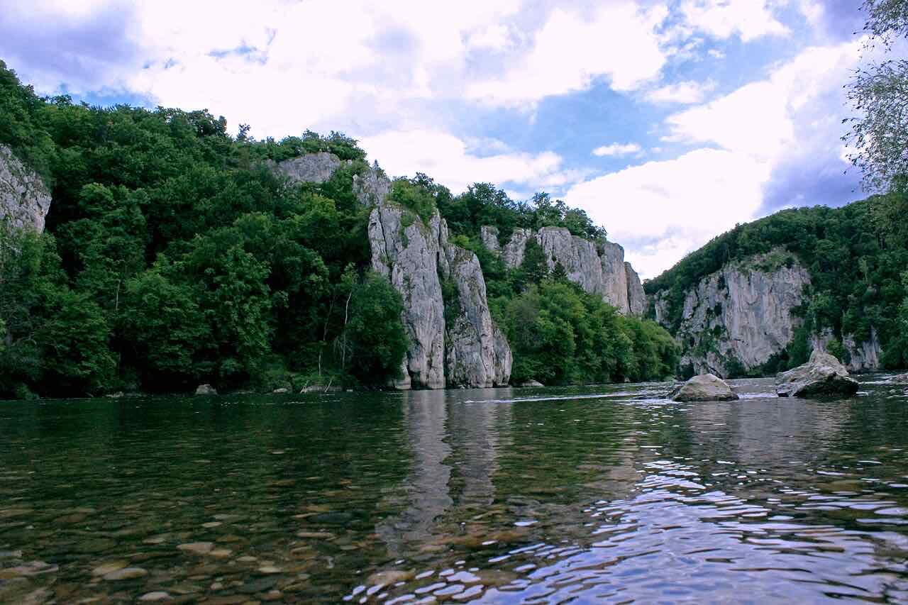 Pale limestone cliffs and green woodland on both sides of the Danube gorge at Weltenburg