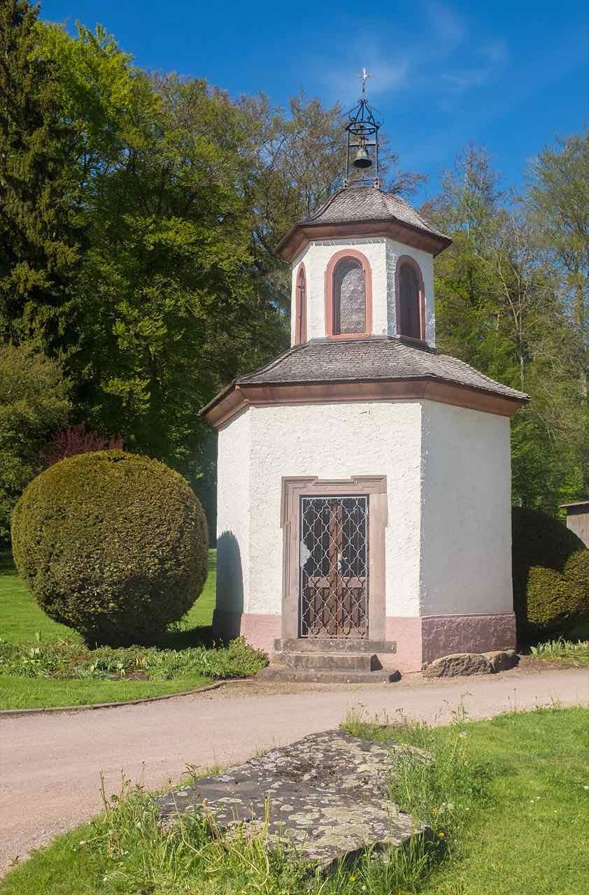 The small white Hammerkapelle with a bell turret among trees and lawns in the Kurpark in Villingen