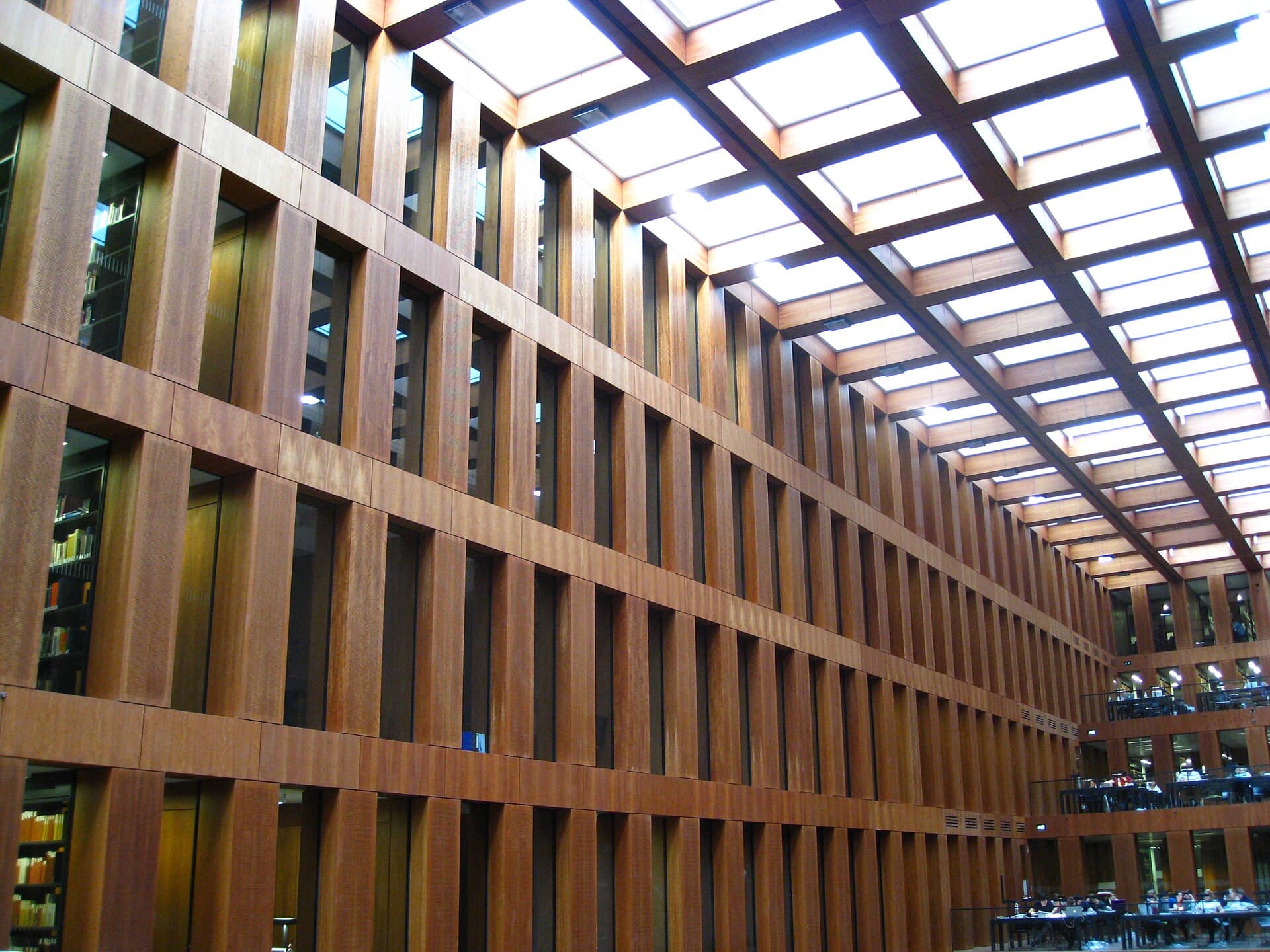 Students working in the wooden atrium of the Grimm-Zentrum library, Humboldt University Berlin