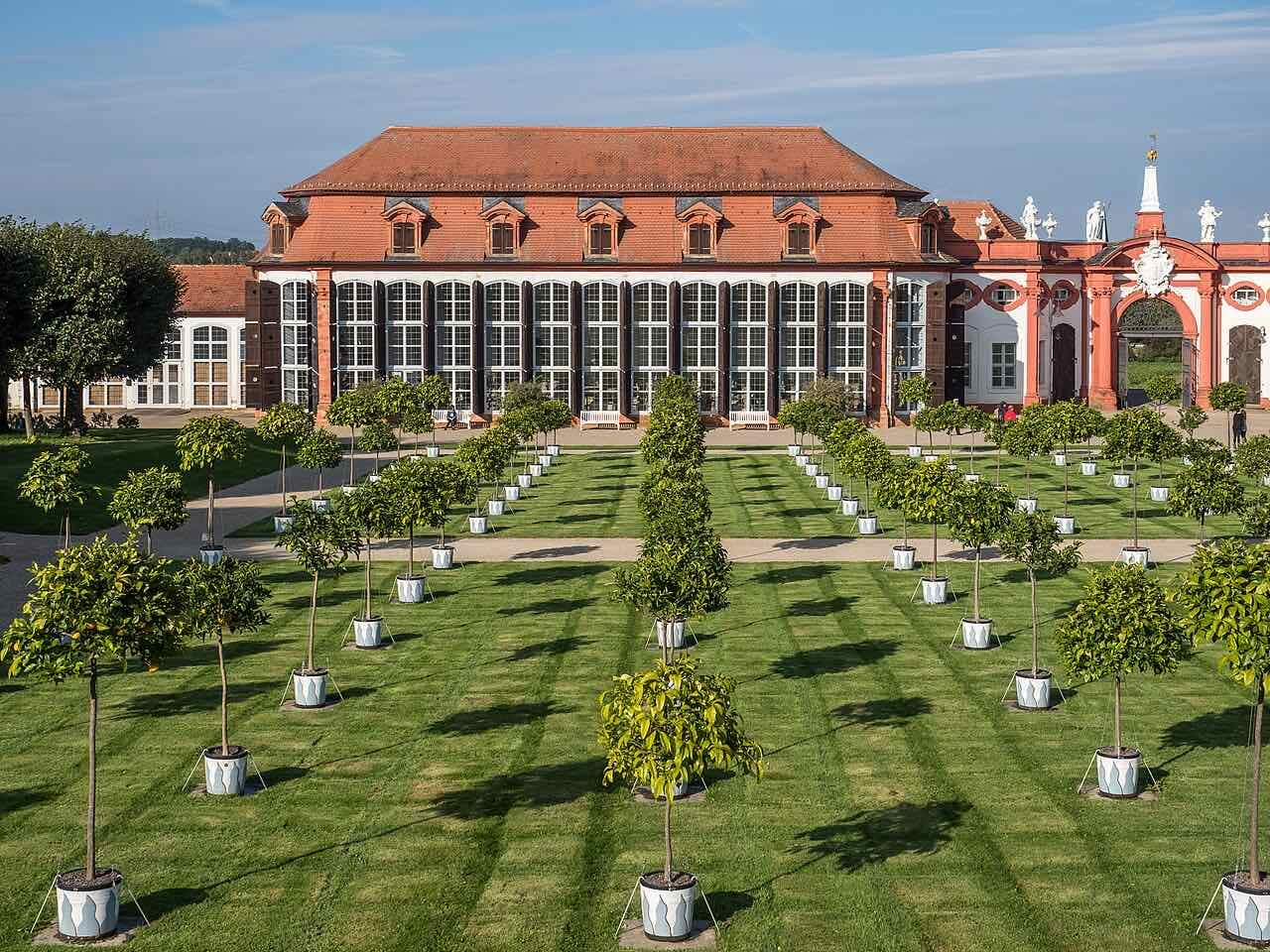 The long orangery of Seehof castle in Memmelsdorf, just outside Bamberg, with a formal garden in front