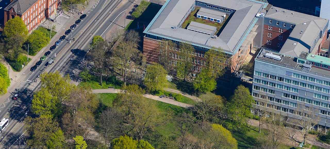 Aerial view of the Hochschule Bremen buildings at Neustadtswall beside a tree-lined park and a tram street