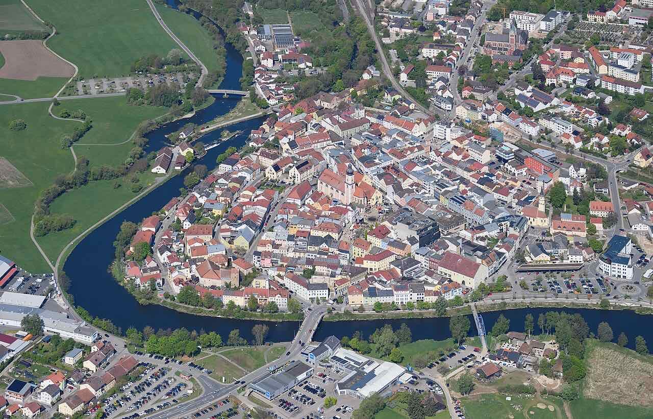 Aerial view of Cham from the southeast, with the town on a bend of the river surrounded by green hills