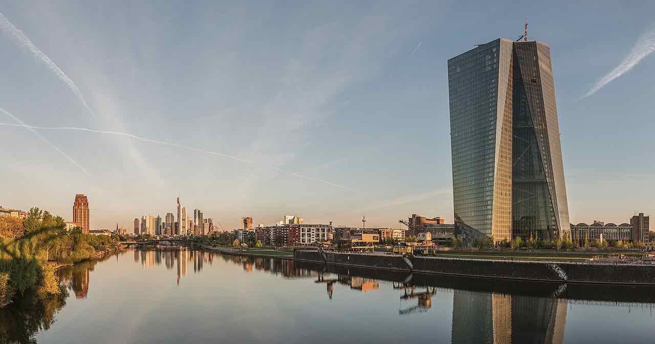The European Central Bank tower in Frankfurt with the skyline behind it at dawn