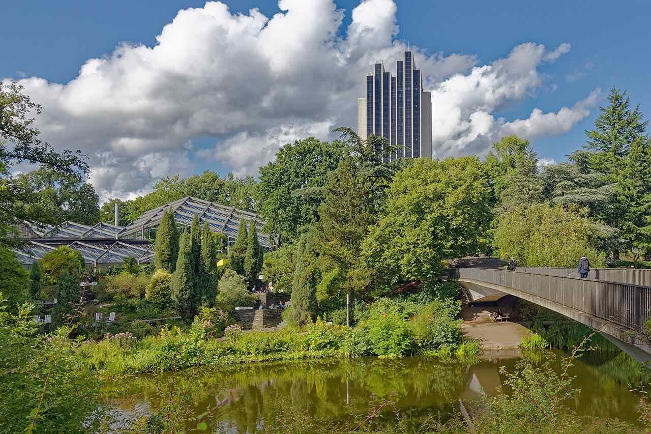 The eastern lake in Planten un Blomen park with the botanical greenhouses behind it in summer