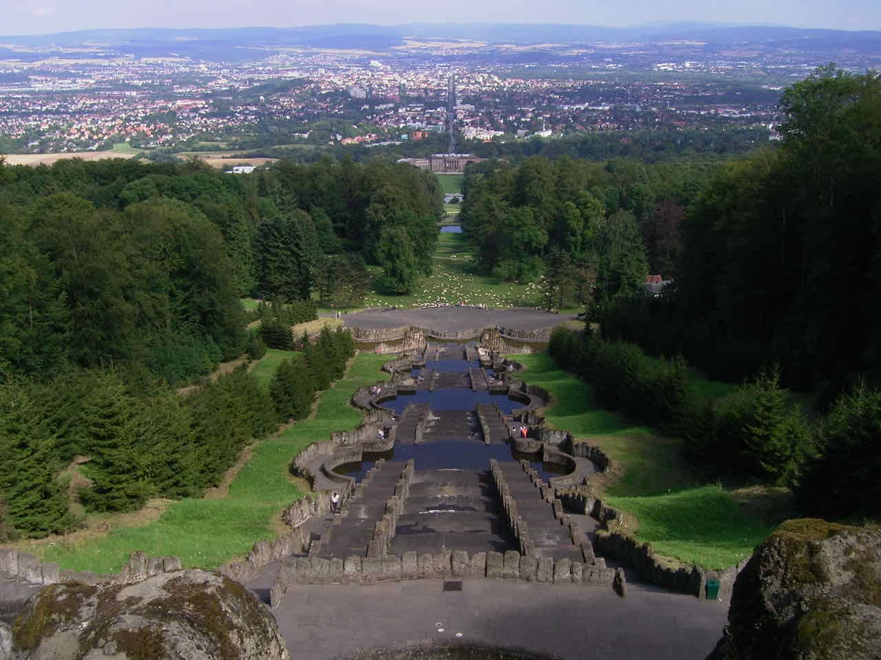 The Bergpark cascades seen from the Herkules monument, with the green park falling away and the whole city of Kassel spread out in the basin below